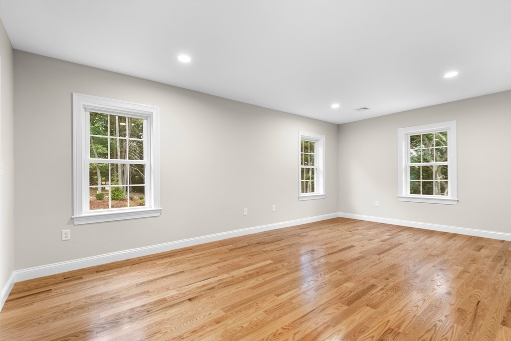345 Grove Street Reading, MA 01867 - Photo 26 of 42 an empty room with wooden floor and windows
