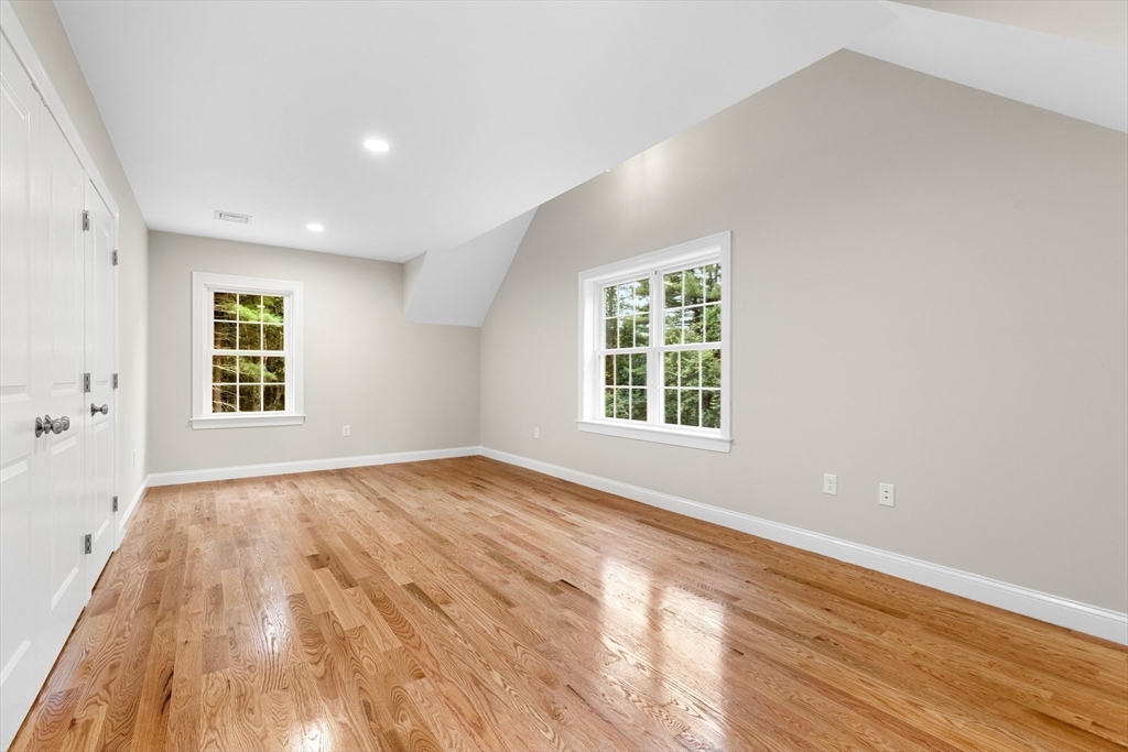 345 Grove Street Reading, MA 01867 - Photo 28 of 42 an empty room with wooden floor and windows