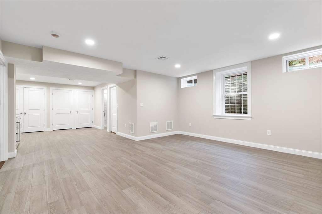 345 Grove Street Reading, MA 01867 - Photo 37 of 42 an empty room with wooden floor and windows