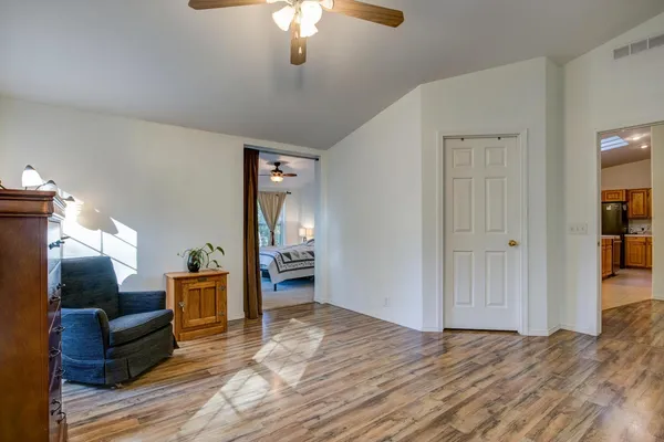 a view of a house with yard and trees in the background