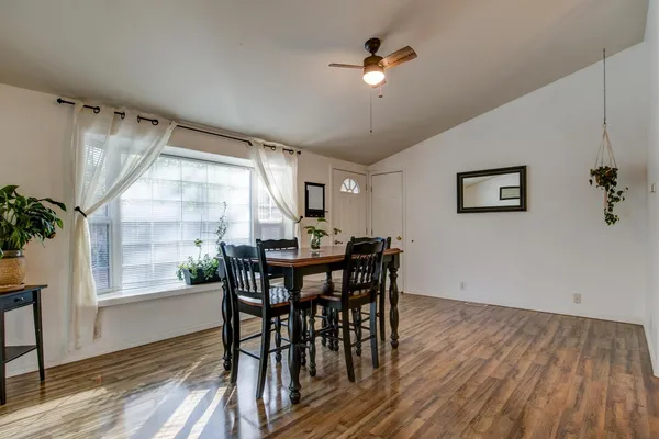 a view of a dining room with furniture and wooden floor