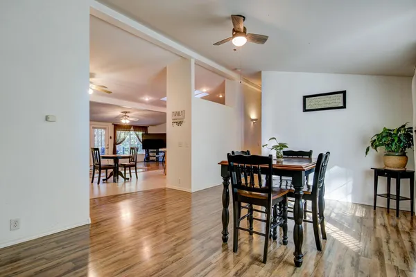 a view of a dining room with furniture and chandelier
