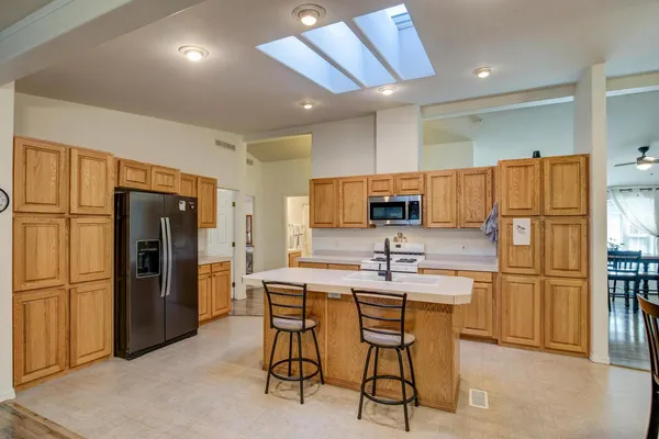 a kitchen with stainless steel appliances granite countertop a refrigerator a sink and dishwasher