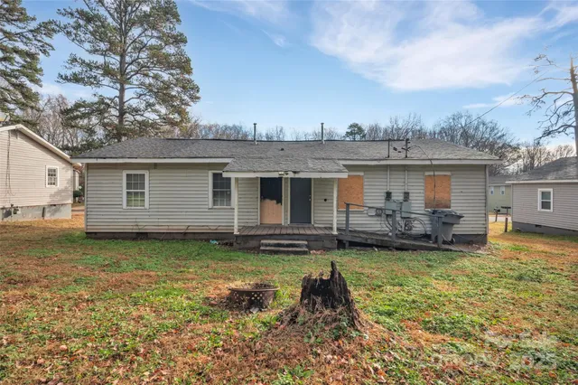 a view of a house with a patio and a yard