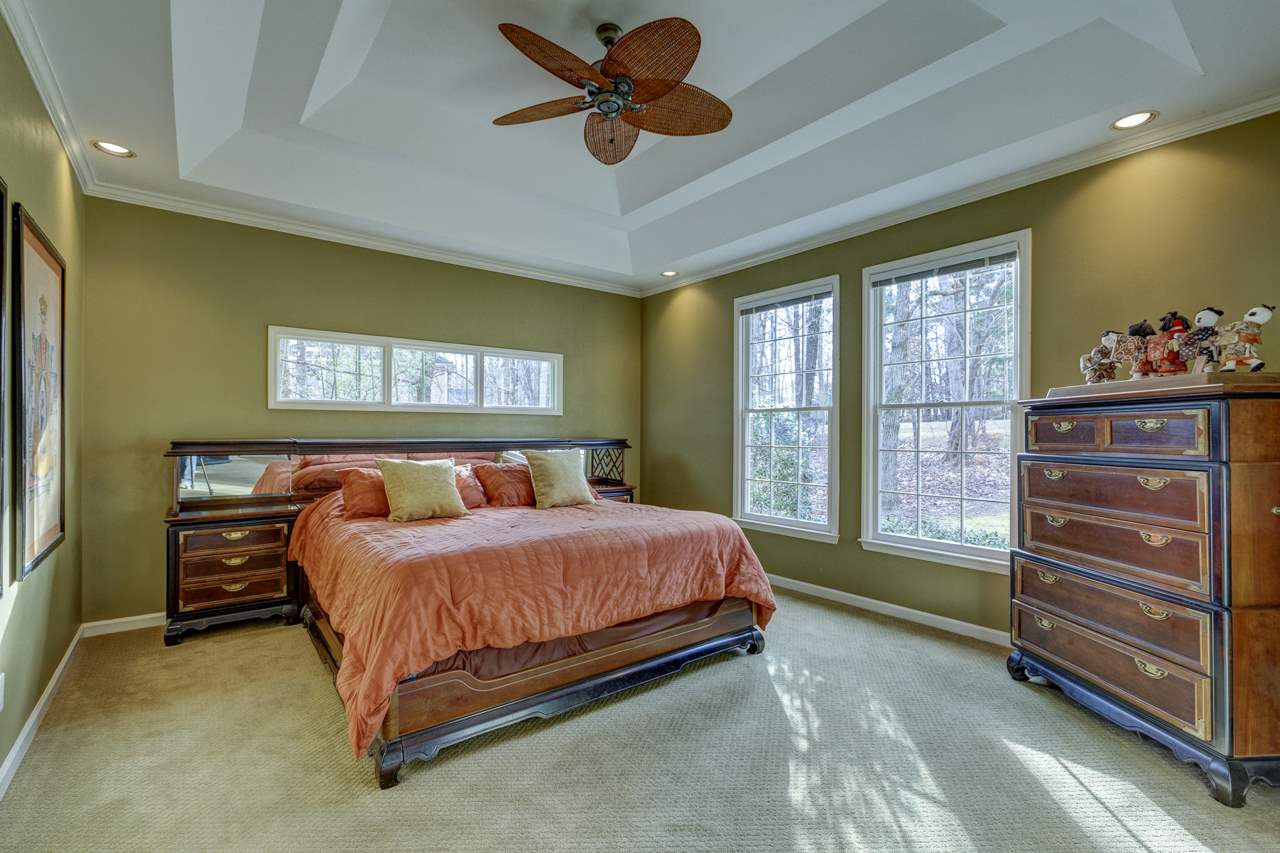 12312 Galway Drive Raleigh, NC 27613 - Photo 12 of 25 The first floor master suite boasts a double step up trey with recessed lighting, ceiling fan, upgraded carpet, triple window, two single windows, and a sitting area with a bay window and built-in cabinets. Master Suite