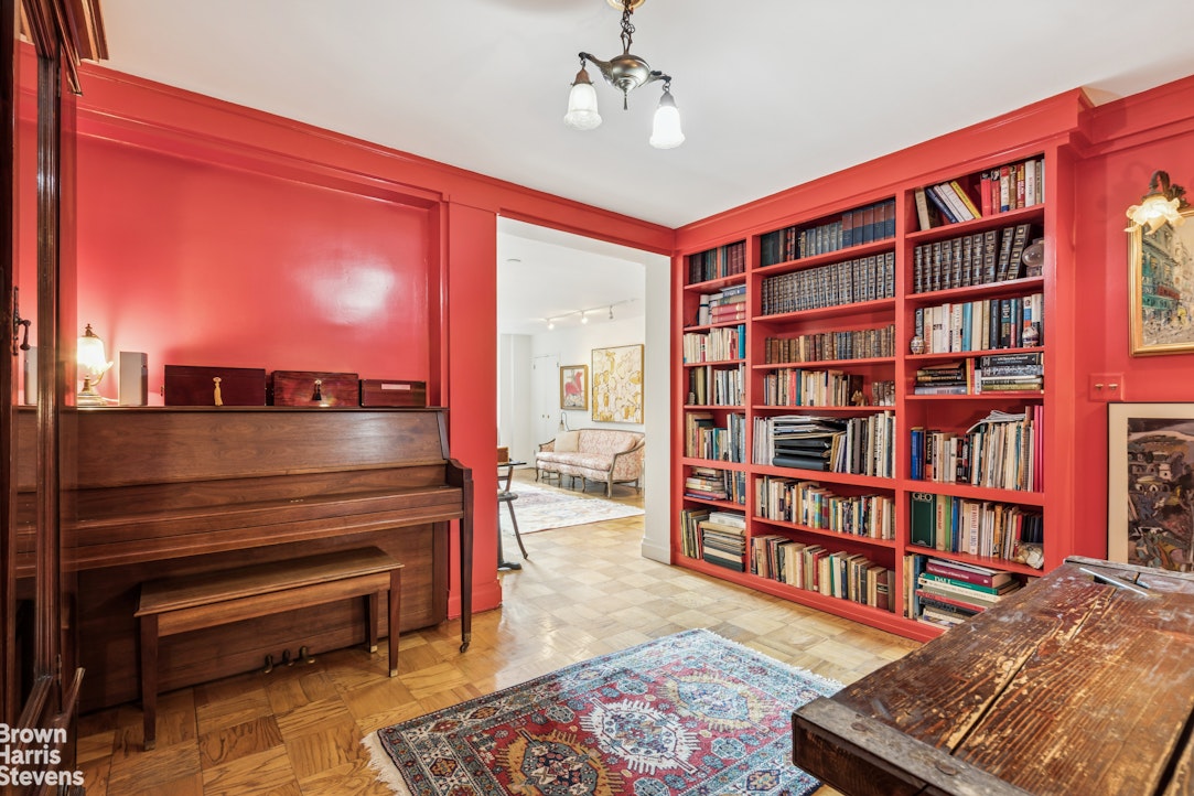 305 East 40th Street, Unit 4J Manhattan, NY 10016 - Photo 11 of 17 a living room with furniture and a book shelf