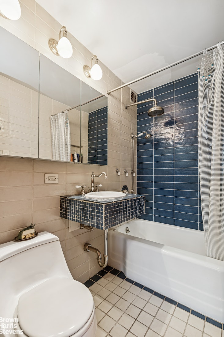 305 East 40th Street, Unit 4J Manhattan, NY 10016 - Photo 12 of 17 a bathroom with a sink toilet and shower