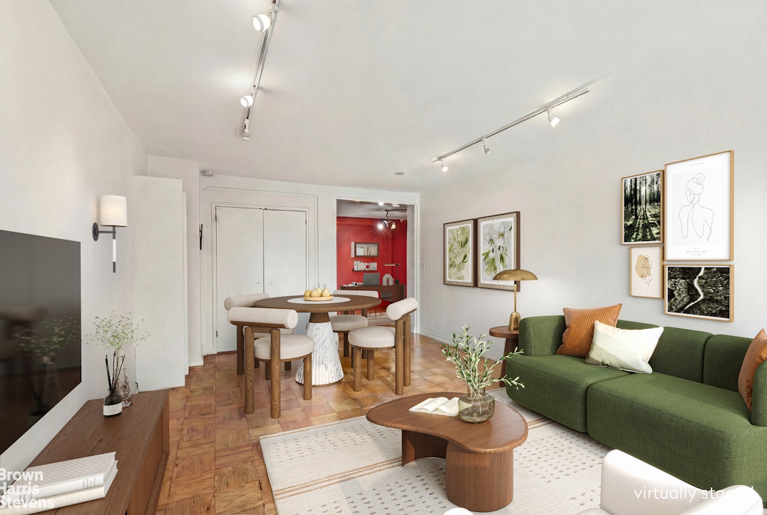 305 East 40th Street, Unit 4J Manhattan, NY 10016 - Photo 3 of 17 a living room with furniture a rug and a chandelier