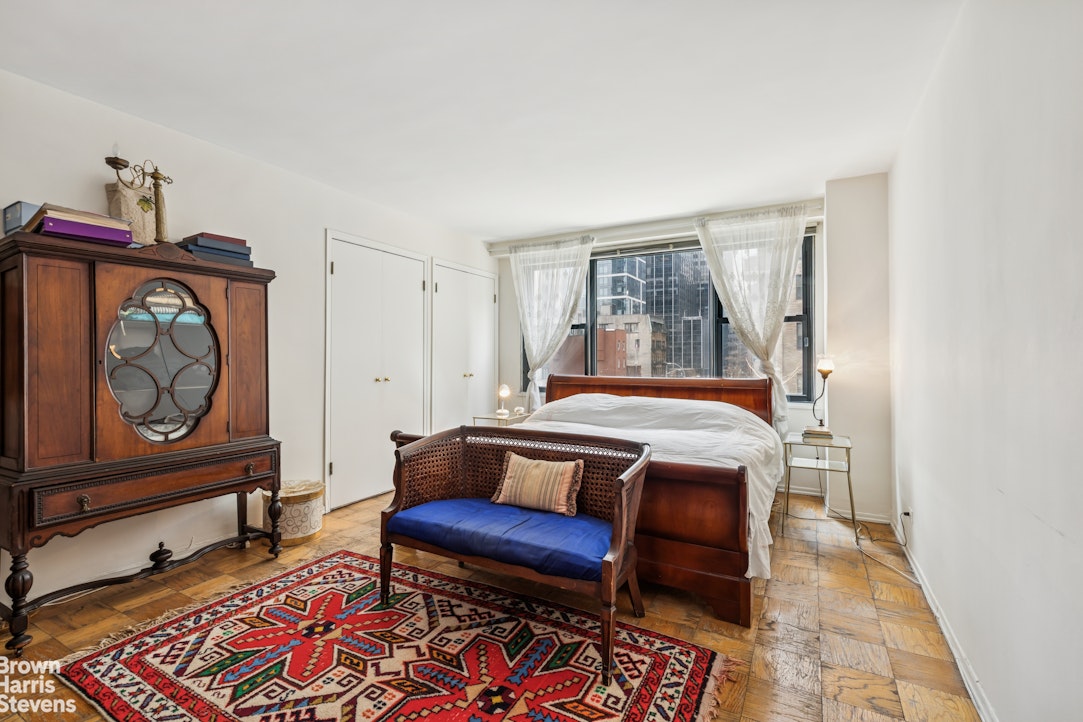 305 East 40th Street, Unit 4J Manhattan, NY 10016 - Photo 7 of 17 a bedroom with furniture and a window