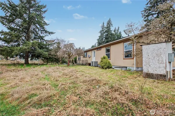 a view of backyard with wooden fence