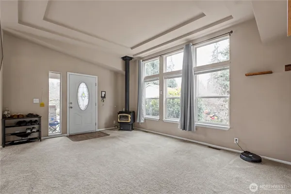 an empty room with windows and closet