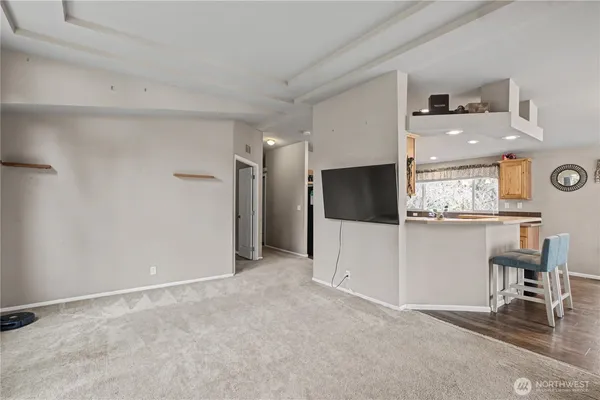 a view of a livingroom with an empty space and a window