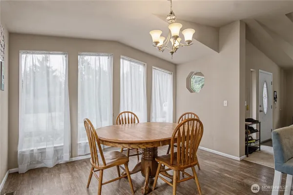 a view of a dining room with furniture wooden floor and chandelier