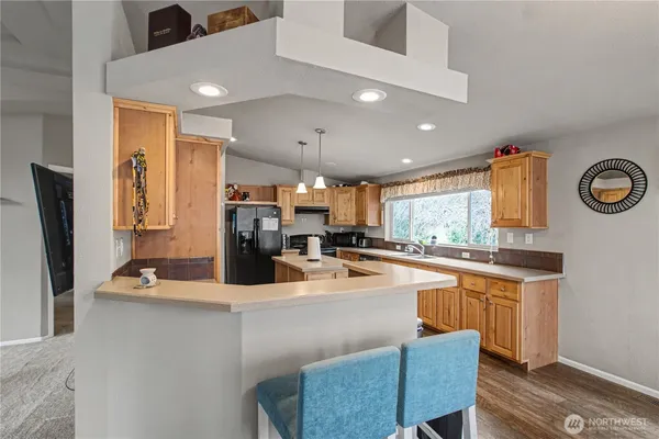 a kitchen with stainless steel appliances granite countertop a sink refrigerator and microwave