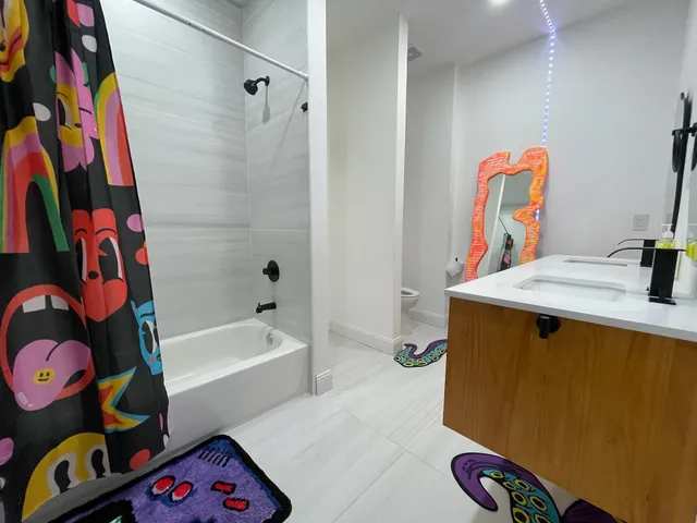 a bedroom with two beds and a desk