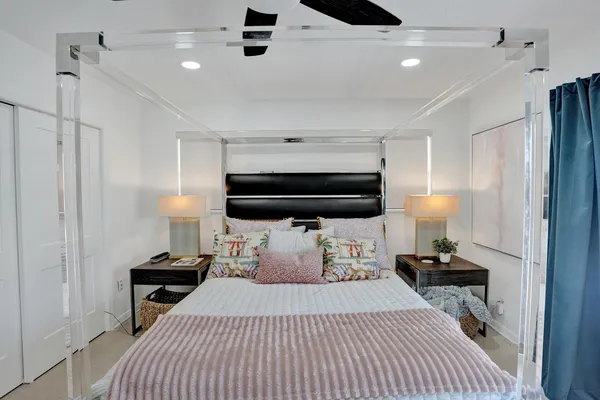 a bedroom with furniture and a large window