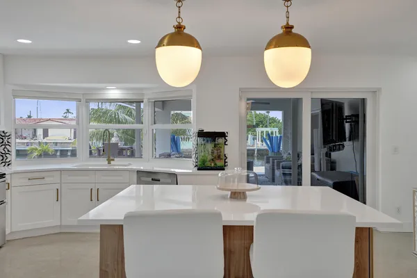 a kitchen with appliances a sink and a window