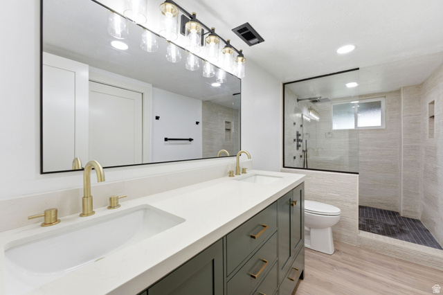 871 Bonita Way Centerville, UT 84014 - Photo 30 of 61 Dual vanity featuring a quartz countertop and gold-finish faucets