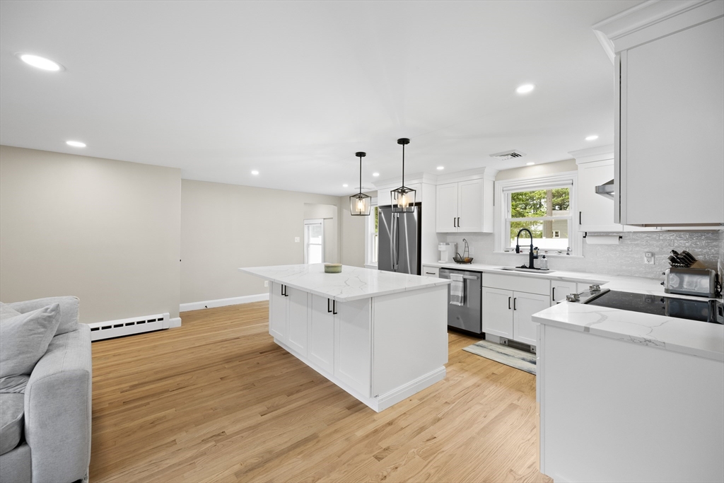 24 Francis Road Sharon, MA 02067 - Photo 12 of 41 a living room with stainless steel appliances kitchen island granite countertop a sink cabinets and wooden floor