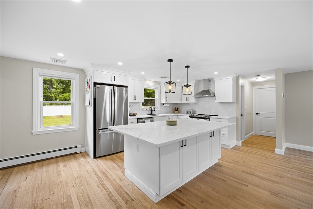 24 Francis Road Sharon, MA 02067 - Photo 14 of 41 a kitchen with stainless steel appliances a sink stove and wooden floor