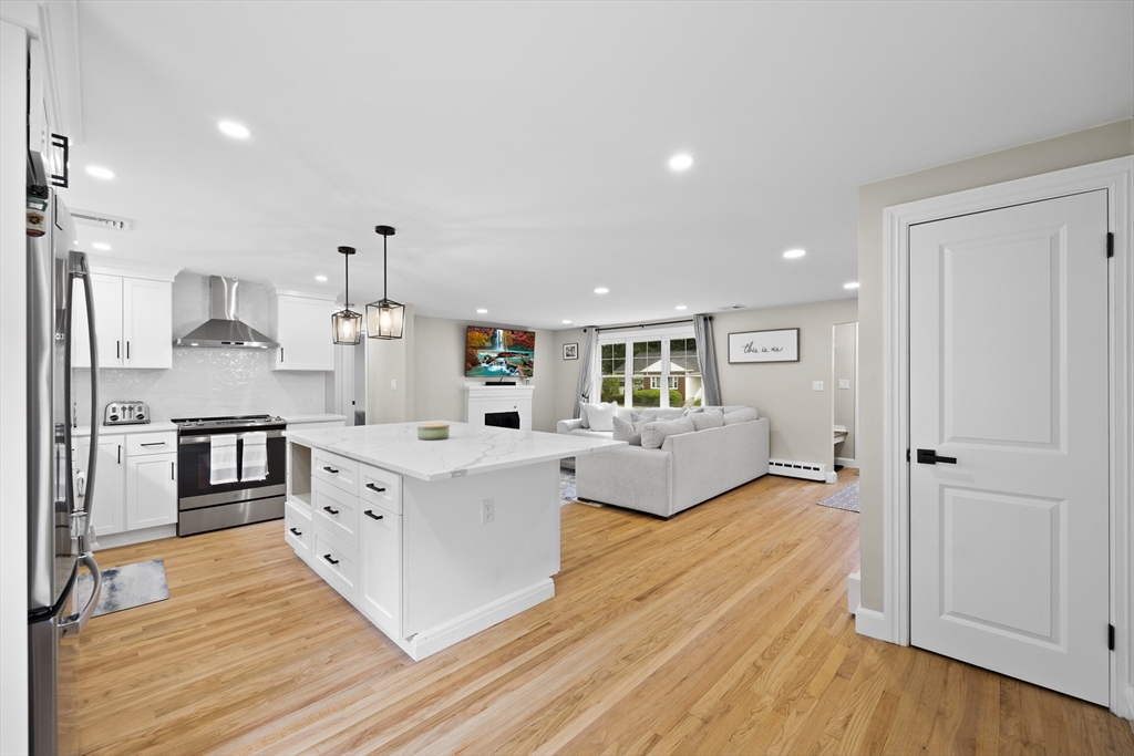 24 Francis Road Sharon, MA 02067 - Photo 17 of 41 a large white kitchen with cabinets wooden floor and stainless steel appliances