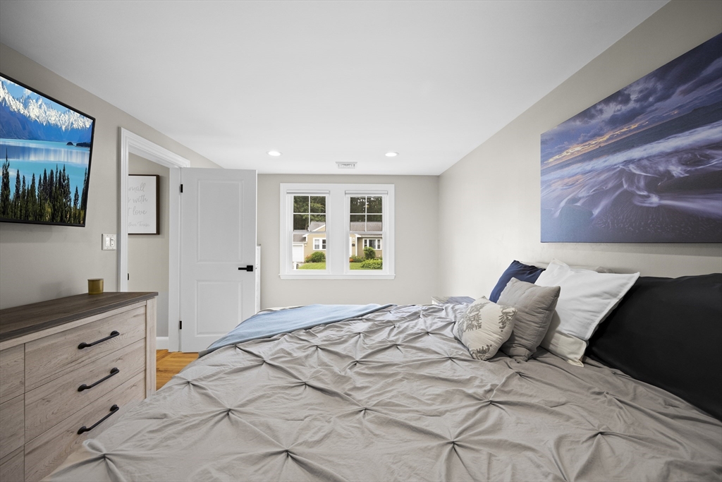 24 Francis Road Sharon, MA 02067 - Photo 21 of 41 a bedroom with a large bed and a flat tv screen on dresser
