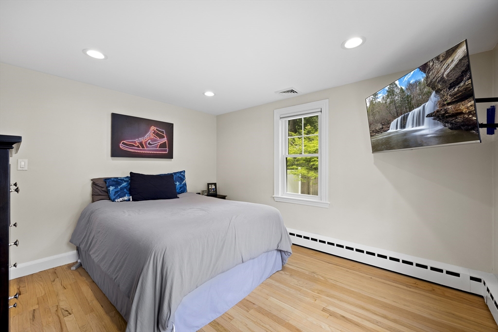 24 Francis Road Sharon, MA 02067 - Photo 24 of 41 a bedroom with a bed and a flat screen tv