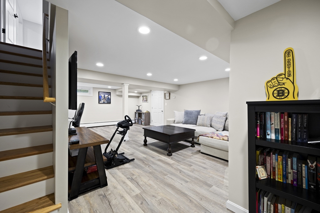 24 Francis Road Sharon, MA 02067 - Photo 28 of 41 a living room with furniture and a book shelf