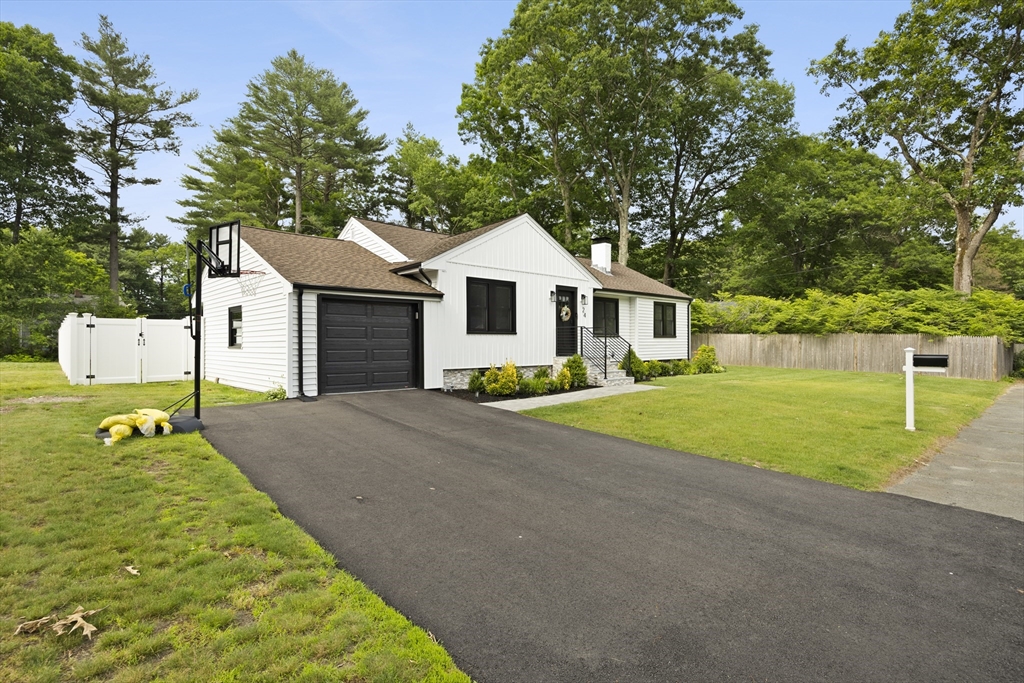 24 Francis Road Sharon, MA 02067 - Photo 4 of 41 a front view of a house with a yard and garage