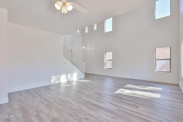 a large kitchen with stainless steel appliances granite countertop a stove a sink dishwasher and a refrigerator with wooden floor