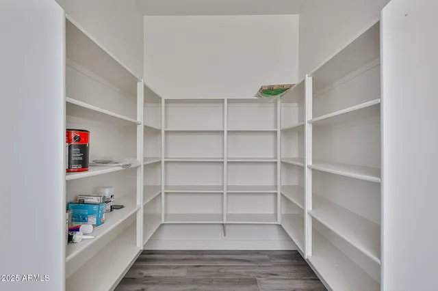 a kitchen with stainless steel appliances granite countertop hardwood floor sink stove and wooden cabinets