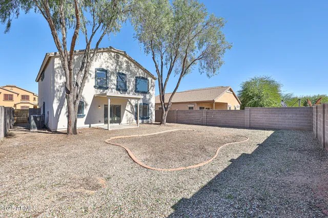 a front view of a house with yard and parking