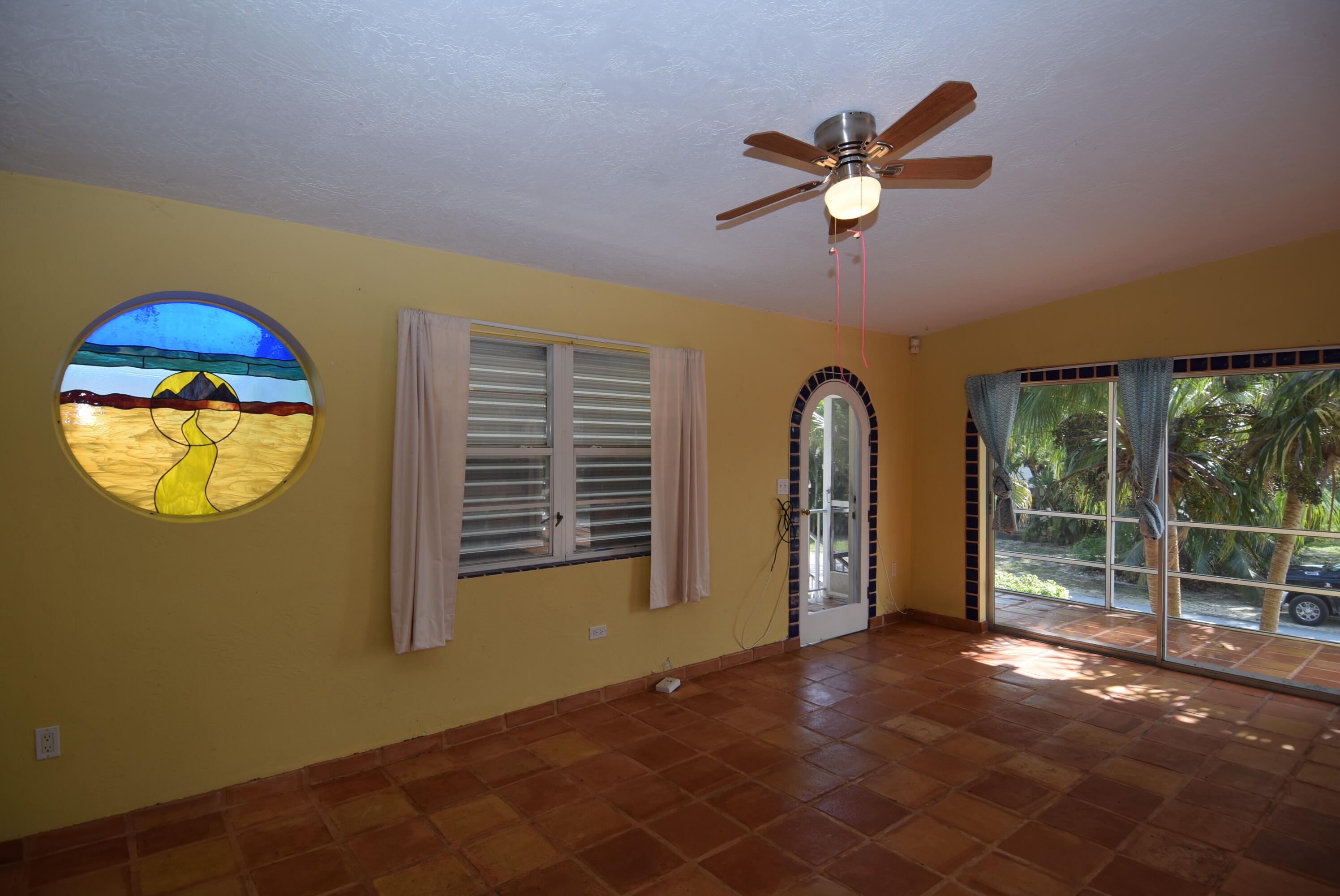 60 Southeast Marlin Avenue Key Largo, FL 33037 - Photo 16 of 46 a view of a livingroom with a ceiling fan and window