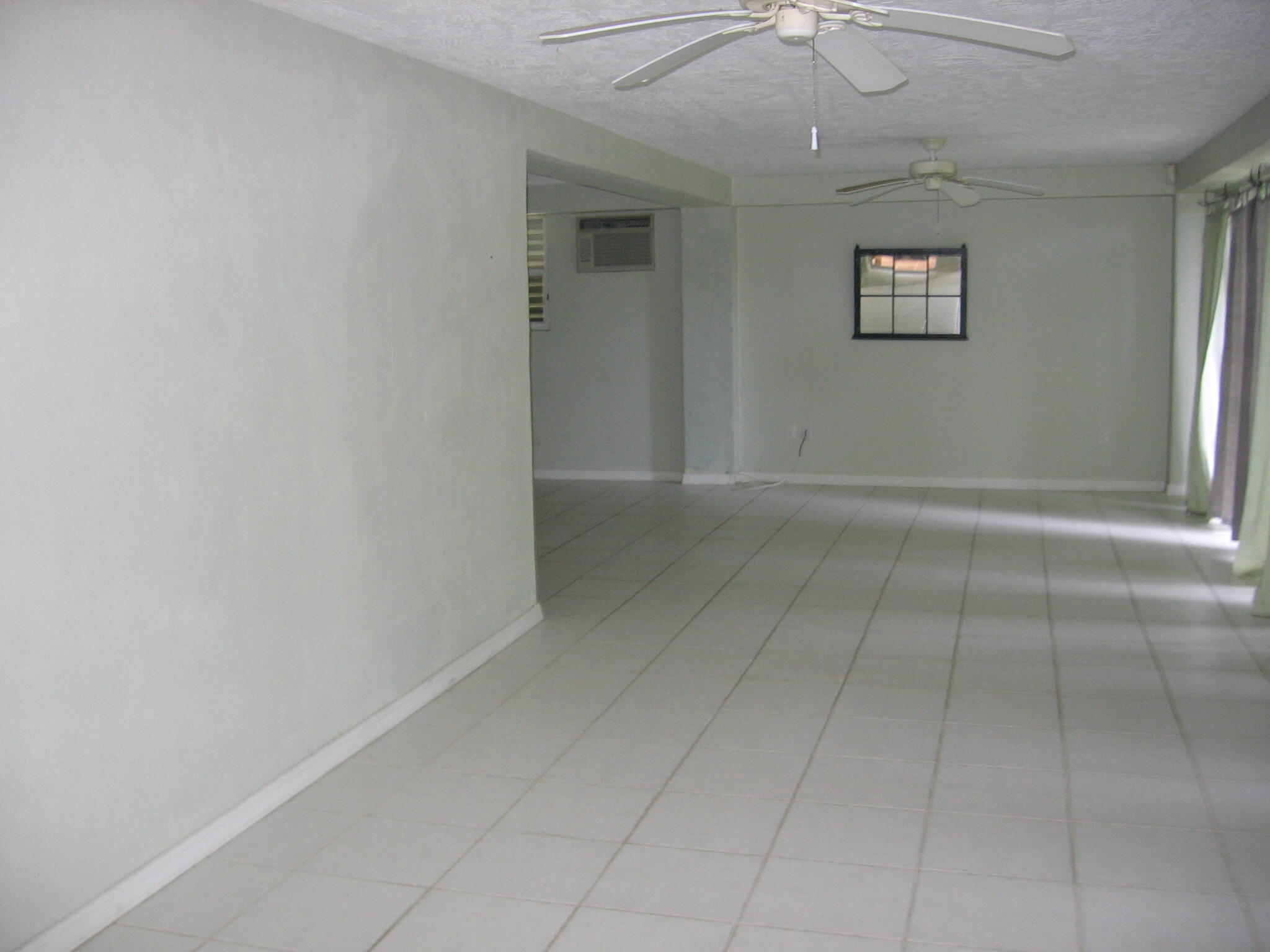60 Southeast Marlin Avenue Key Largo, FL 33037 - Photo 34 of 46 an empty room with a ceiling fan and windows