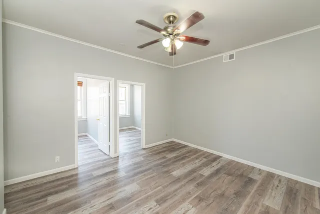 wooden floor in an empty room with a window