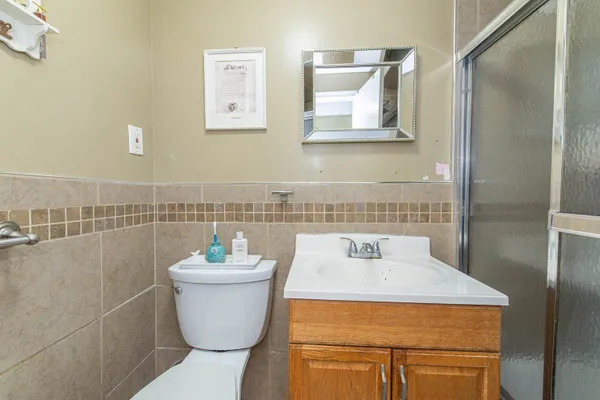 a bathroom with a sink a toilet and a mirror