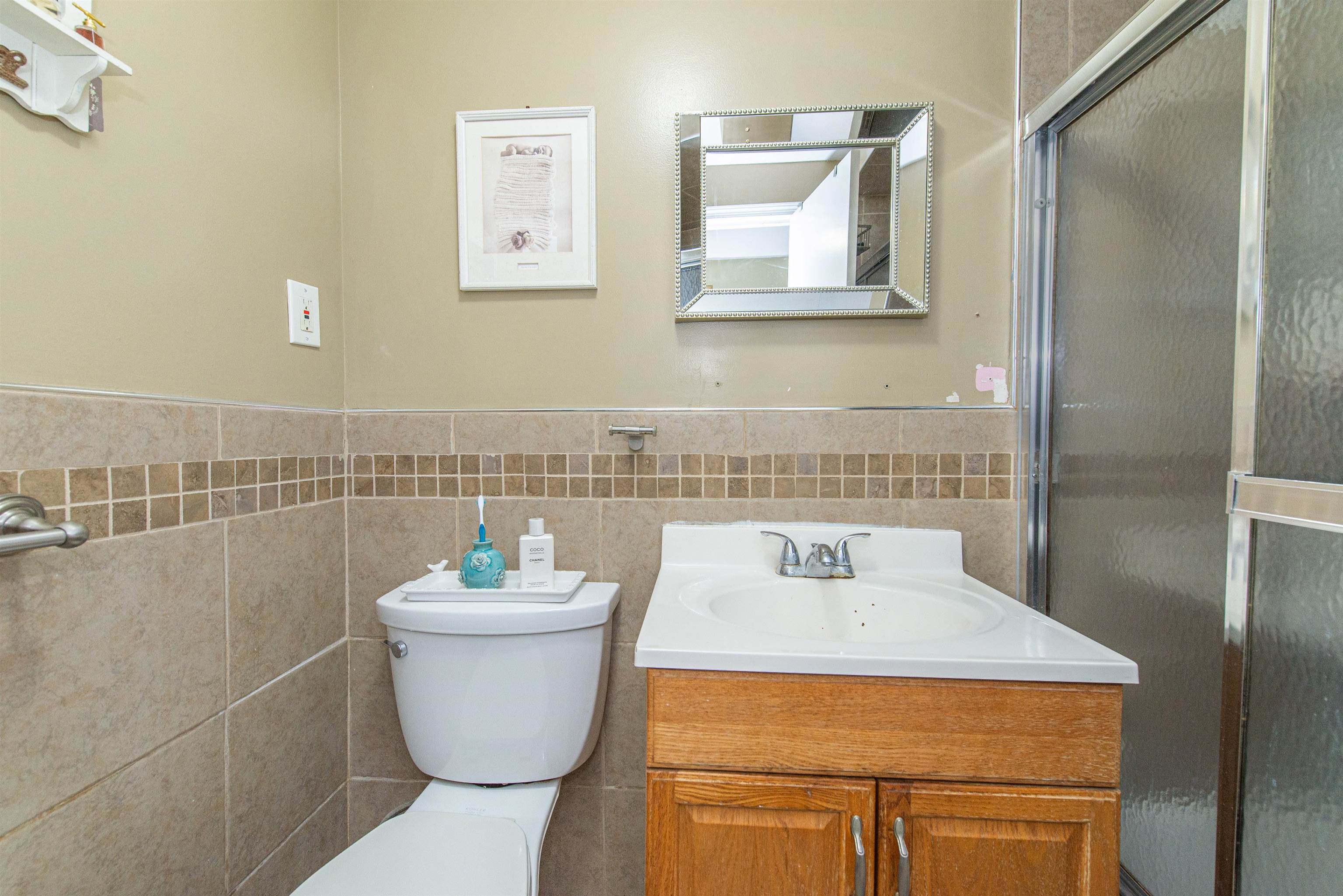 413 24th Street Union City, NJ 07087 - Photo 12 of 19 a bathroom with a sink a toilet and a mirror
