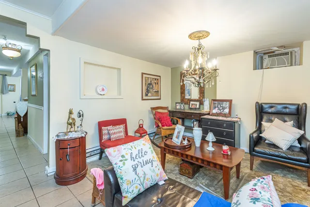 a living room with furniture and a chandelier