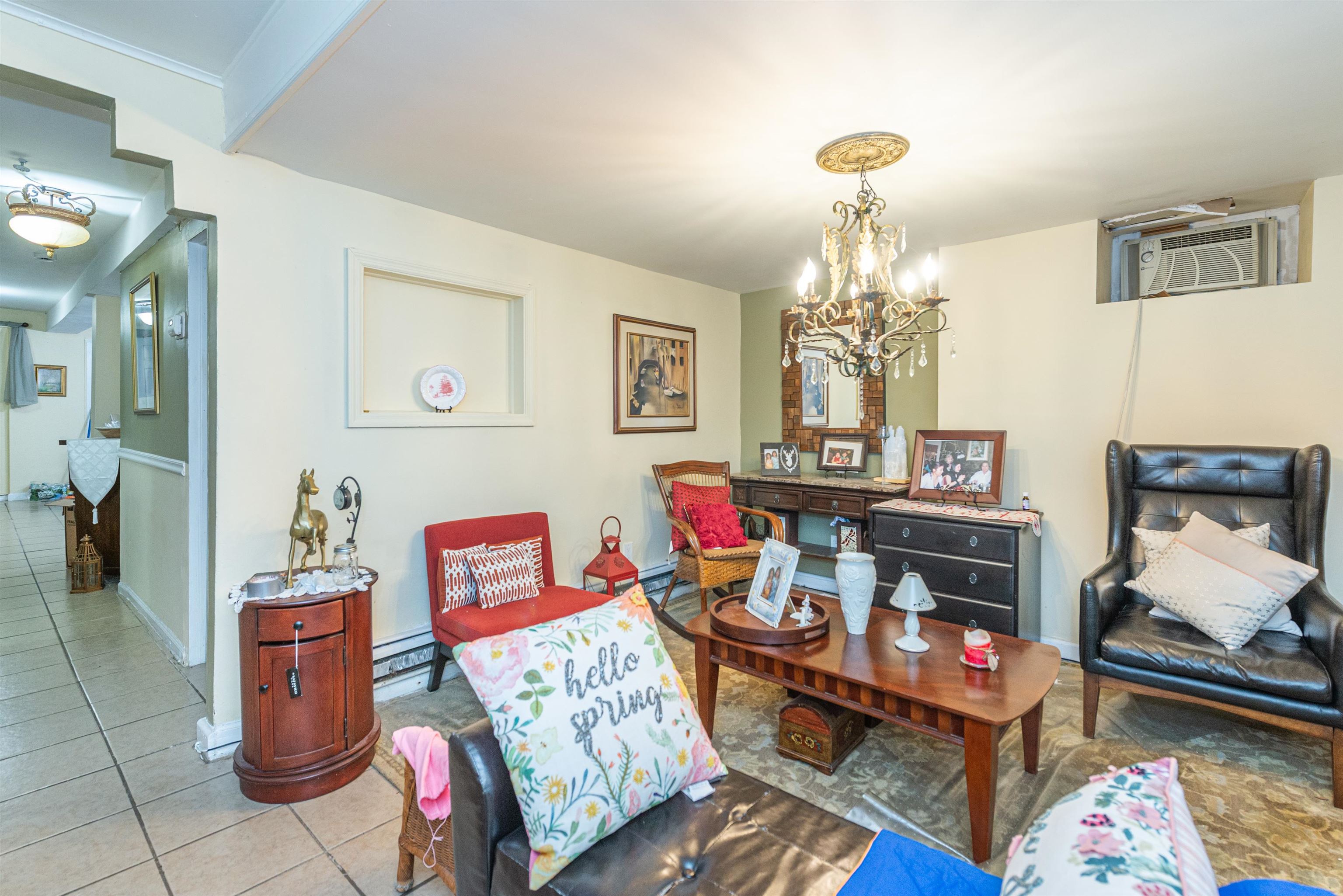 413 24th Street Union City, NJ 07087 - Photo 15 of 19 a living room with furniture and a chandelier