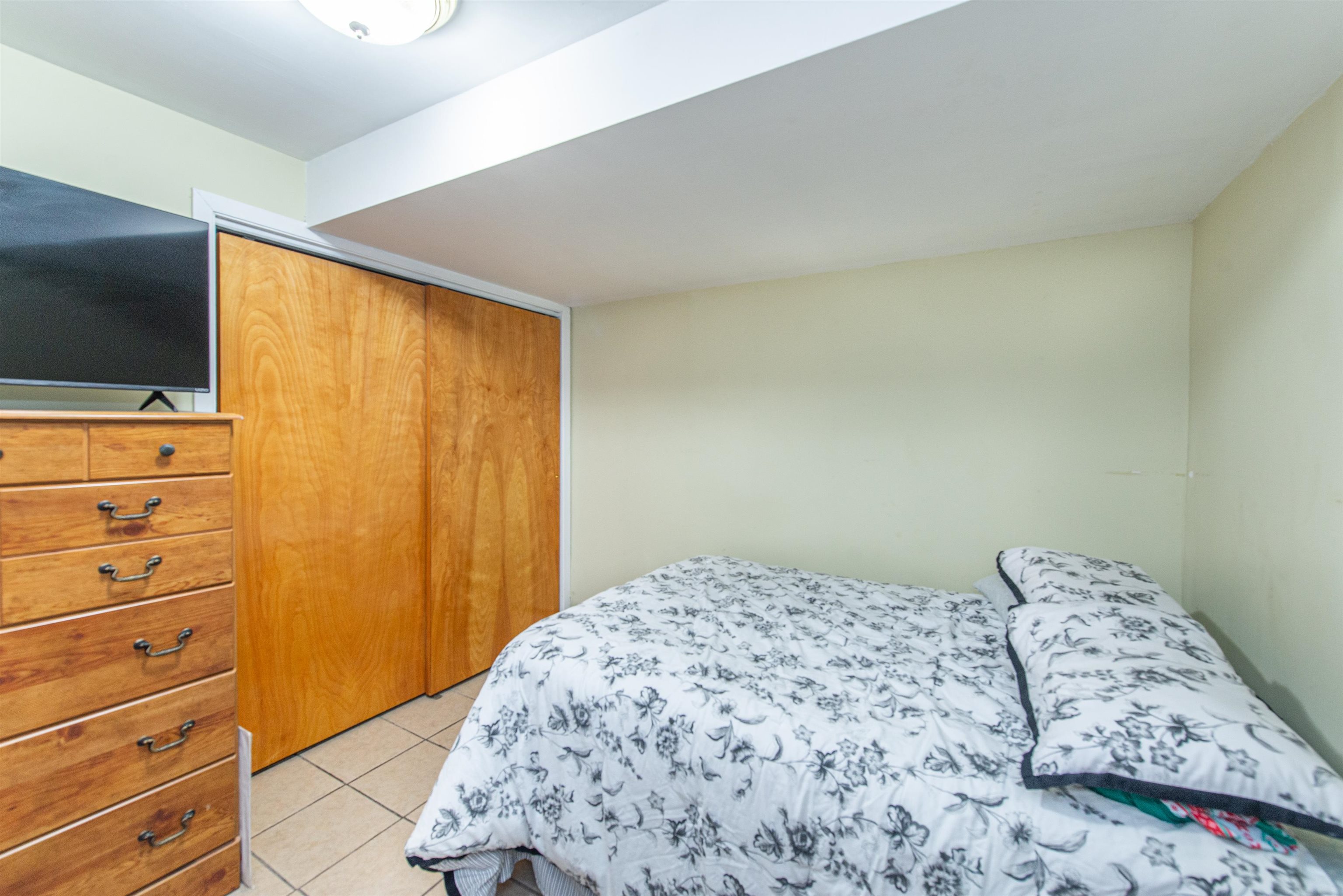 413 24th Street Union City, NJ 07087 - Photo 16 of 19 a bedroom with a bed and a flat screen tv