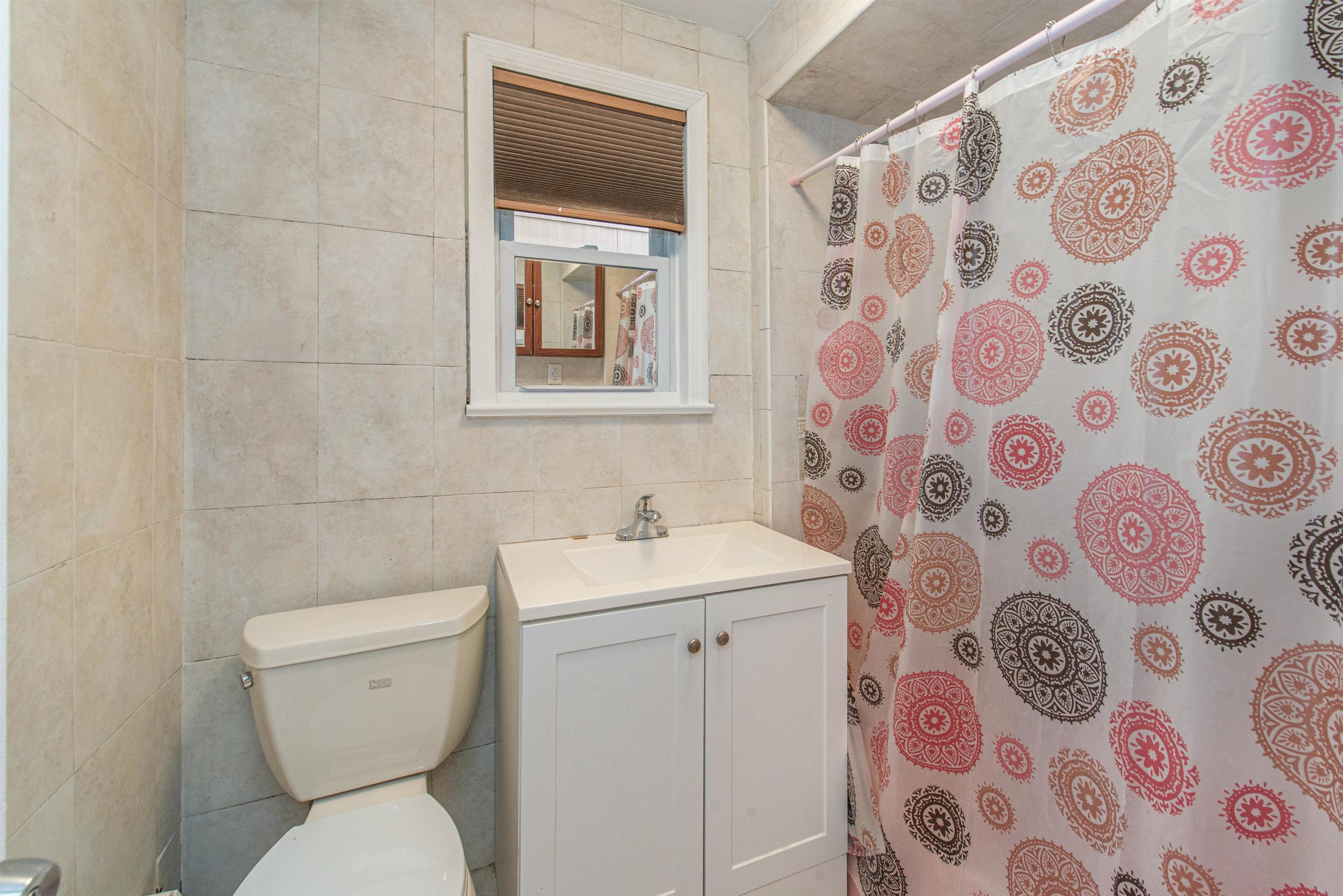 413 24th Street Union City, NJ 07087 - Photo 17 of 19 a bathroom with a toilet and a sink a mirror