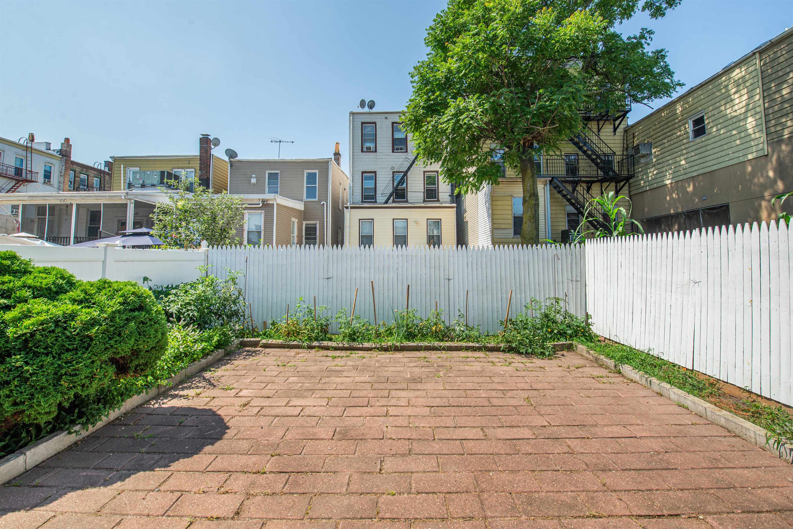 413 24th Street Union City, NJ 07087 - Photo 18 of 19 a front view of a house with garden