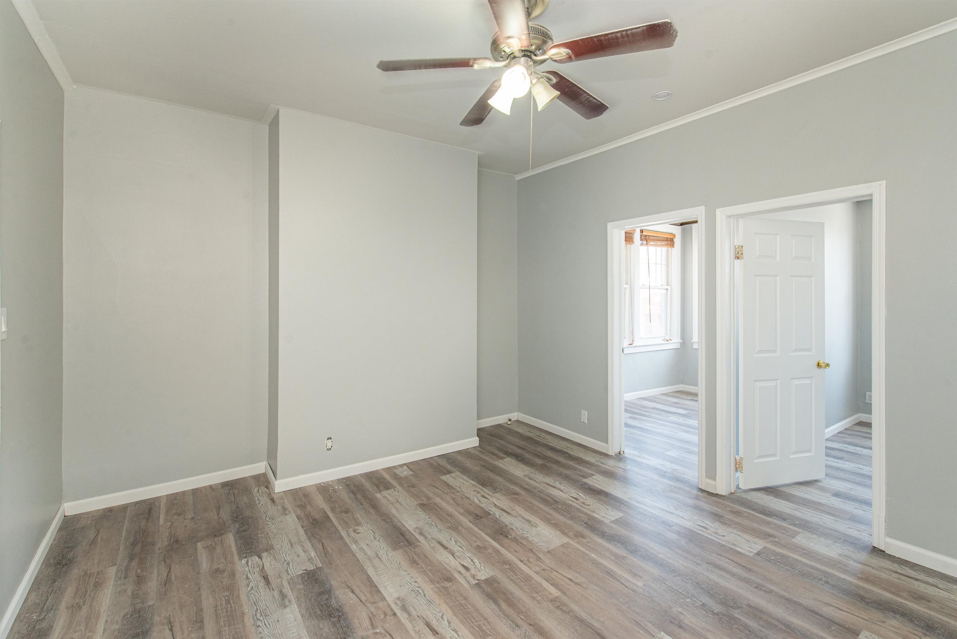 413 24th Street Union City, NJ 07087 - Photo 4 of 19 an empty room with wooden floor closet and windows