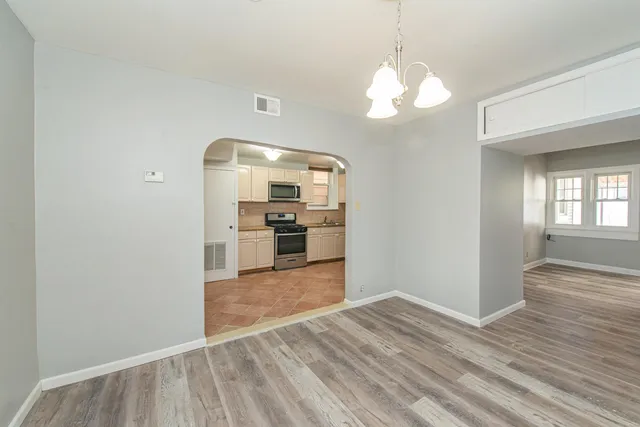 a view of a kitchen with cabinets and stainless steel appliances