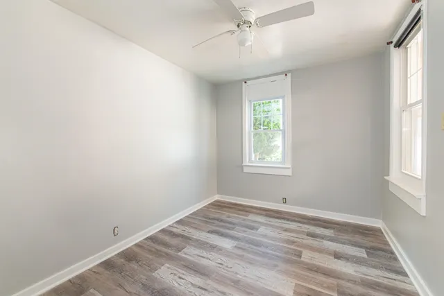 wooden floor in an empty room with a window