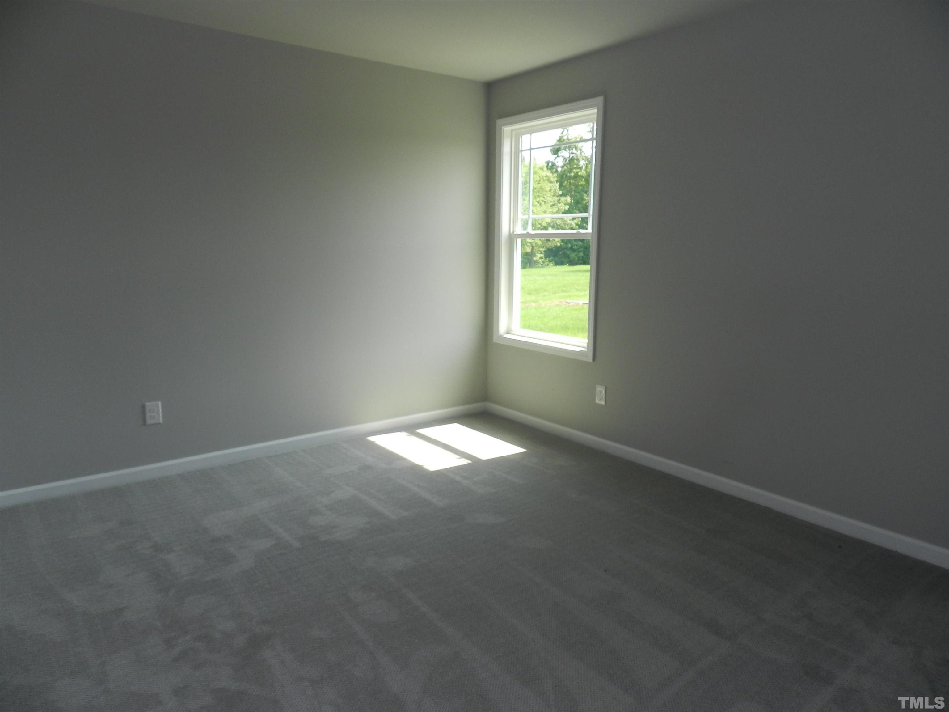 232 Tractor Place Willow Spring, NC 27592 - Photo 8 of 14 an empty room with a window