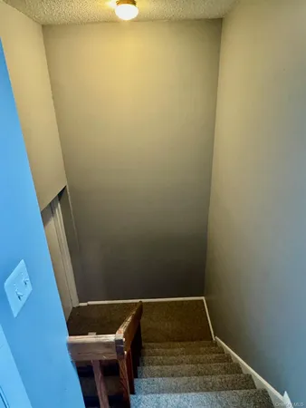 a small space with wooden floor and a sink