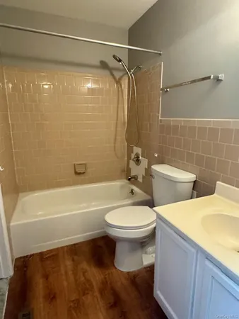 a bathroom with a toilet a sink and bathtub
