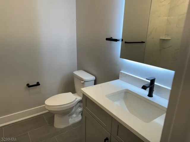 a kitchen with stainless steel appliances wooden floors wooden cabinets a refrigerator and a sink