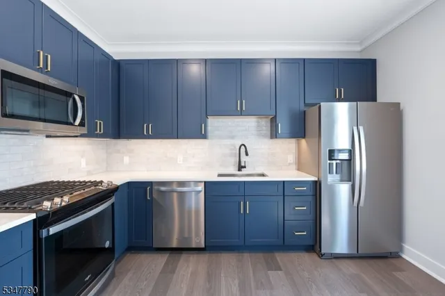 a kitchen with a sink stove and microwave